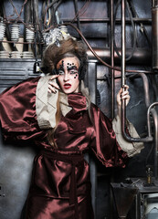 Aggressive stylish steampunk woman in a creative interior.