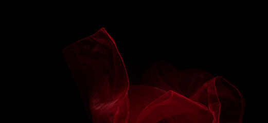 Red organza fabric flying in curve shape, Piece of textile Red organza fabric throw fall in air....