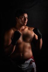 Fototapeta premium studio portrait latin American male fighter of mixed martial arts on black background 