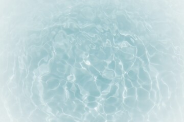 Blue water with ripples on the surface. Defocus blurred transparent blue colored clear calm water surface texture with splashes and bubbles. Water waves with shining pattern texture background.