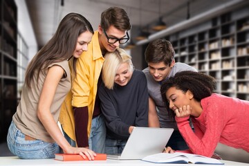 Happy young students team in library
