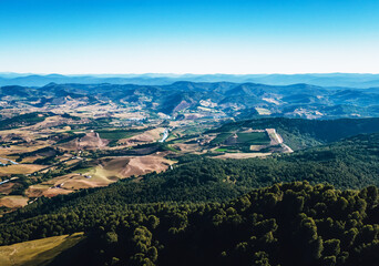Mountains cradle valleys from above.
