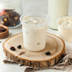 Cottage cheese made from natural milk with raisins in a plastic jar. Fermented dairy products.