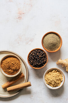 Ground spices in bowls on a neutral background