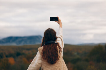 Mountain Woman Enjoying Freedom and Nature, Taking a Selfie with Phone