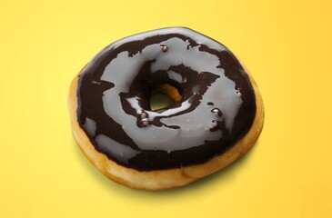Sweet tasty chocolate donut on pastel background