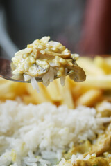Closeup of fork pick rice mixed with chicken 