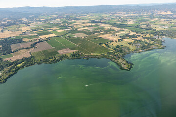 Aerial view of the polluted green waters of Clear Lake and the environmental effects of agricultural runoff causing algae blooms