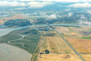 Aerial view of patterns of agricultural fields and the San Francisco Bay where it meets the Sacramento River Delta