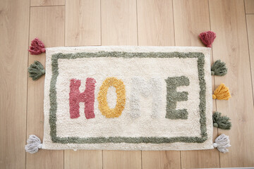 a rug with the word home written on it is on the floor in a hallway
