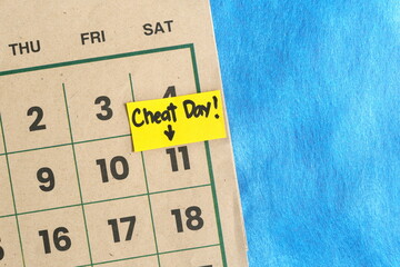 Cheat day concept. Written reminder note on a calendar.