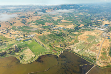 Aerial view of patterns of agricultural fields and the San Francisco Bay where it meets the Sacramento River Delta
