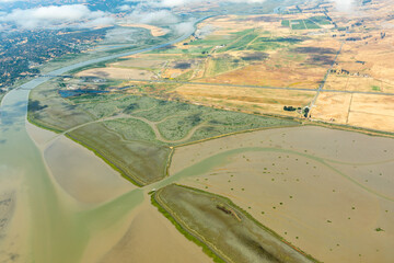 Aerial view of patterns of agricultural fields and the San Francisco Bay where it meets the Sacramento River Delta