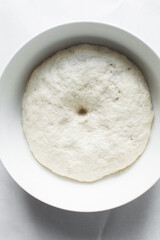 Checking if bread dough is proofed with finger indent, process of making bread