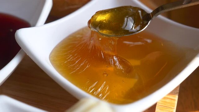 close up of spoon pick fresh honey 