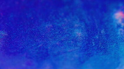 Wet glitter shimmering texture. Defocused blue pink color sparkling particles paint wave flow...