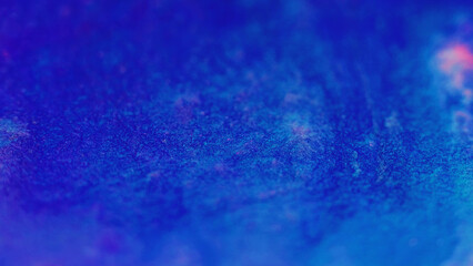 Wet glitter shimmering texture. Defocused blue pink color sparkling particles paint wave flow abstract art background.