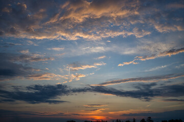 Clouds that reflect varying shades of pink, orange and blue