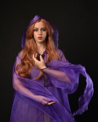 close up portrait of beautiful female model with long red hair, wearing a purple fairy  fantasy...