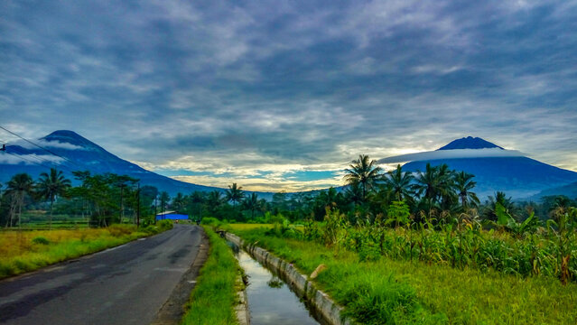 Sindoro mountain and Sumbing mountain is a twin mountain in Central Java Indonesia, This view is sunrise moment from ricefield Wonosobo Indonesia.