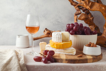 Cheese, grapes, nuts and wine glass on table. Jewish holiday Shavuot concept