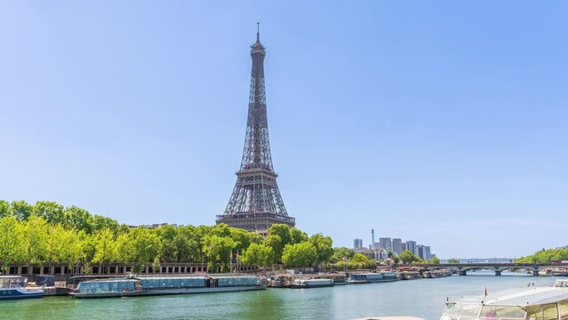 A timelapse of the Eiffel Tower along the river Seine with flyboats passing by with motion blur.Sunny but cloudy spring summer day paris city famous riverside bay tower view bridge timelapse panorama