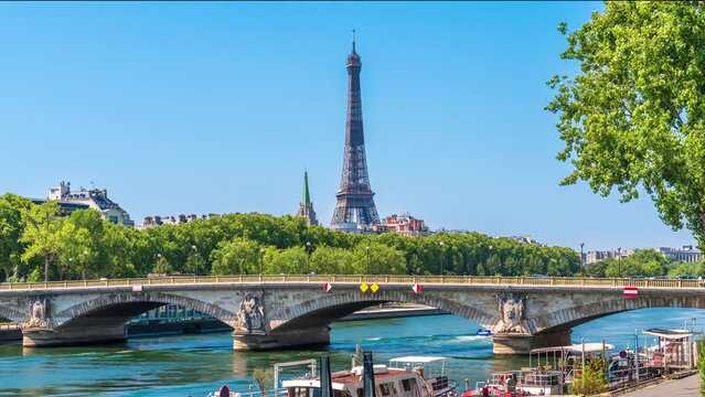 A timelapse of the Eiffel Tower along the river Seine with flyboats passing by with motion blur.Sunny but cloudy spring summer day paris city famous riverside bay tower view bridge timelapse panorama