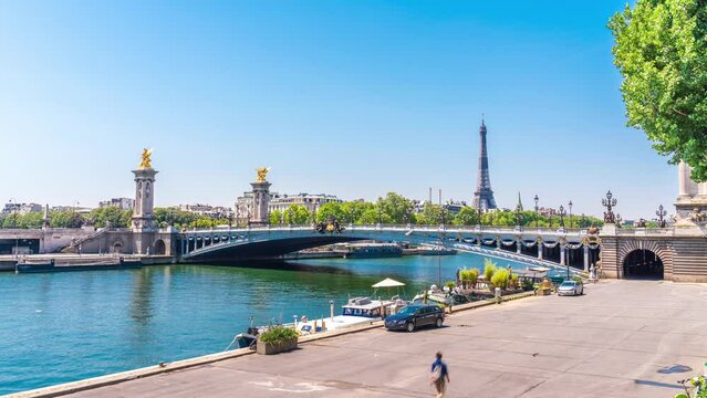 A timelapse of the Eiffel Tower along the river Seine with flyboats passing by with motion blur.Sunny but cloudy spring summer day paris city famous riverside bay tower view bridge timelapse panorama