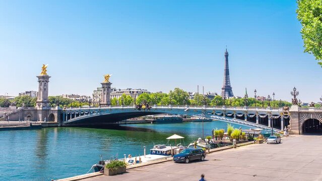 A timelapse of the Eiffel Tower along the river Seine with flyboats passing by with motion blur.Sunny but cloudy spring summer day paris city famous riverside bay tower view bridge timelapse panorama