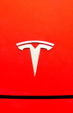 Bangkok ,Thailand ,May -15, 2024 : Close up of Tesla logo on tesla model 3 red background at dealer showroom in siam paragon