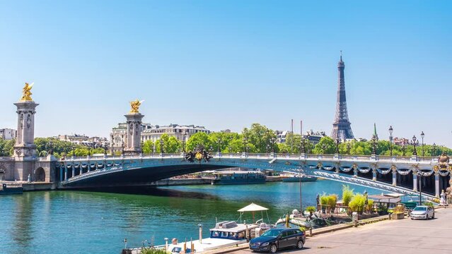 A timelapse of the Eiffel Tower along the river Seine with flyboats passing by with motion blur.Sunny but cloudy spring summer day paris city famous riverside bay tower view bridge timelapse panorama