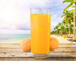 Glass of apricot juice drink on the desk