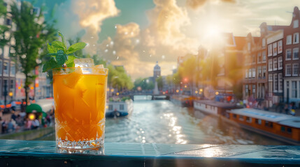 A sunset cocktail by a canal. The golden sun sets behind elegant buildings and a bridge, casting a...