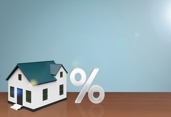 Percentage icon and house model on desk.