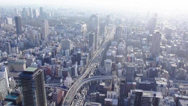 Drone view of Osaka at dawn, city, traffic and Osaka castle in the background