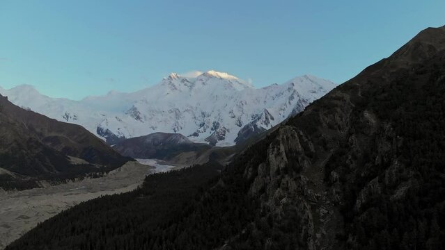 Aerial reveals Nanga Parbat Mountain Pakistan, snowy peaks, blue morning skyline