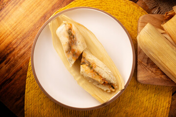 Tamales. hispanic dish typical of Mexico and some Latin American countries. Corn dough wrapped in corn leaves. The tamales are steamed.