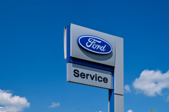 Ford dealer sign, Service, logo sign, in front of blue sky. Ford Motor Company is a american multinational automobile manufacturer headquartered in 	Dearborn, Michigan, US - Karlstadt Main, Germany