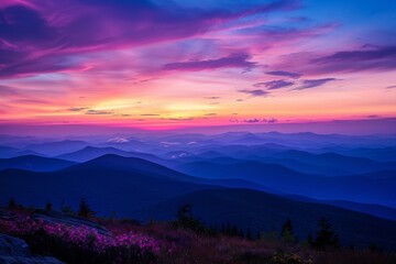 Naklejka premium Vibrant Sunset Over Layered Mountain Ridges