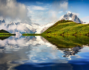 Snowy Schreckhorn peak reflected in te calm waters of Bachalpsee lake.Stunning morning scene of...