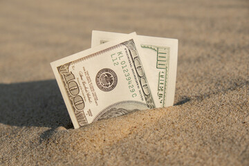 Money american hundred dollar bills in sandy beach. Concept finance saving money for holiday...