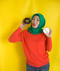 Vertical View Of Young Muslim Woman Holding Donuts With Happy Expression