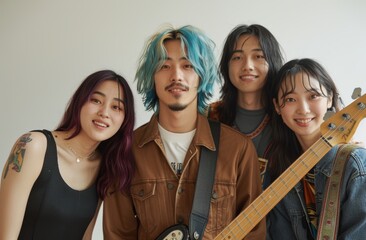 Group portrait of an asian band of four people, singer, guitarist, bassist, and drummer with green...