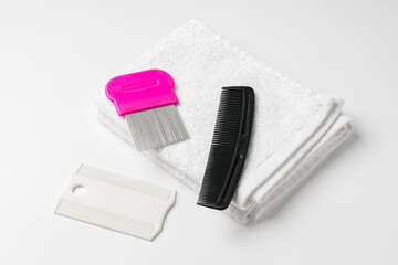 Anti lice combs and towel on white background