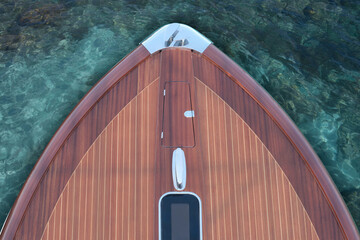 Front part of a wooden Luxury boat top view against a background of azure water. Top view of the...