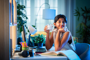 Indian asian girl child having milk while studying at home