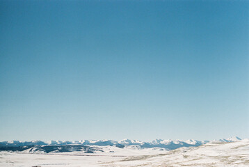 Snowy Montana mountainscape under a vivid blue sky