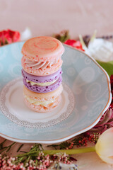 Stack of colorful macarons on a patterned plate