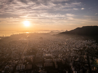 Beautiful sunrise aerial view to mountains and city buildings
