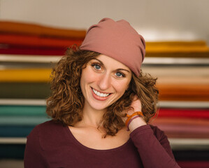 A woman posing confidently, wearing a fashionable headband